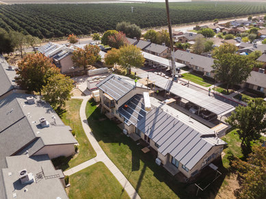 Insulated metal panel roofing being installed as part of a zero net carbon retrofit at Vera Cruz Village