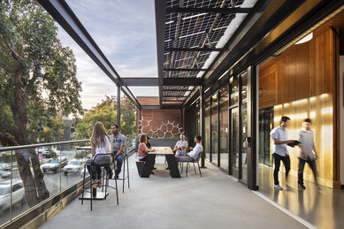 Photograph of employees enjoying second story terrace at DPR Construction's Sacramento Office