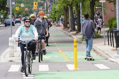 Photograph of two-way bicycle and skateboard traffic in an on-street section of bike path in Ann Arbor, Michigan